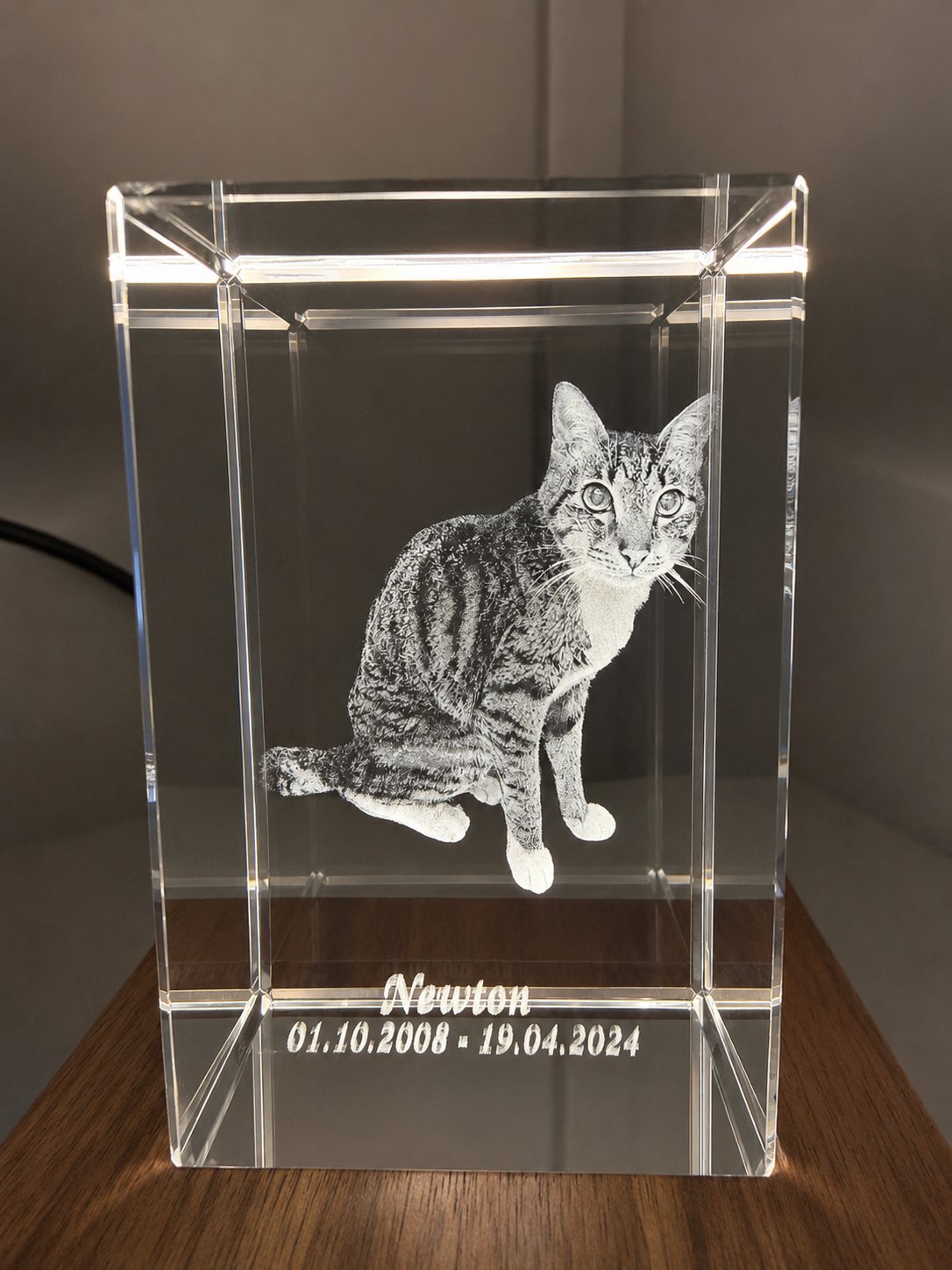 Newton's finished memorial crystal on the desk, his name and dates engraved
