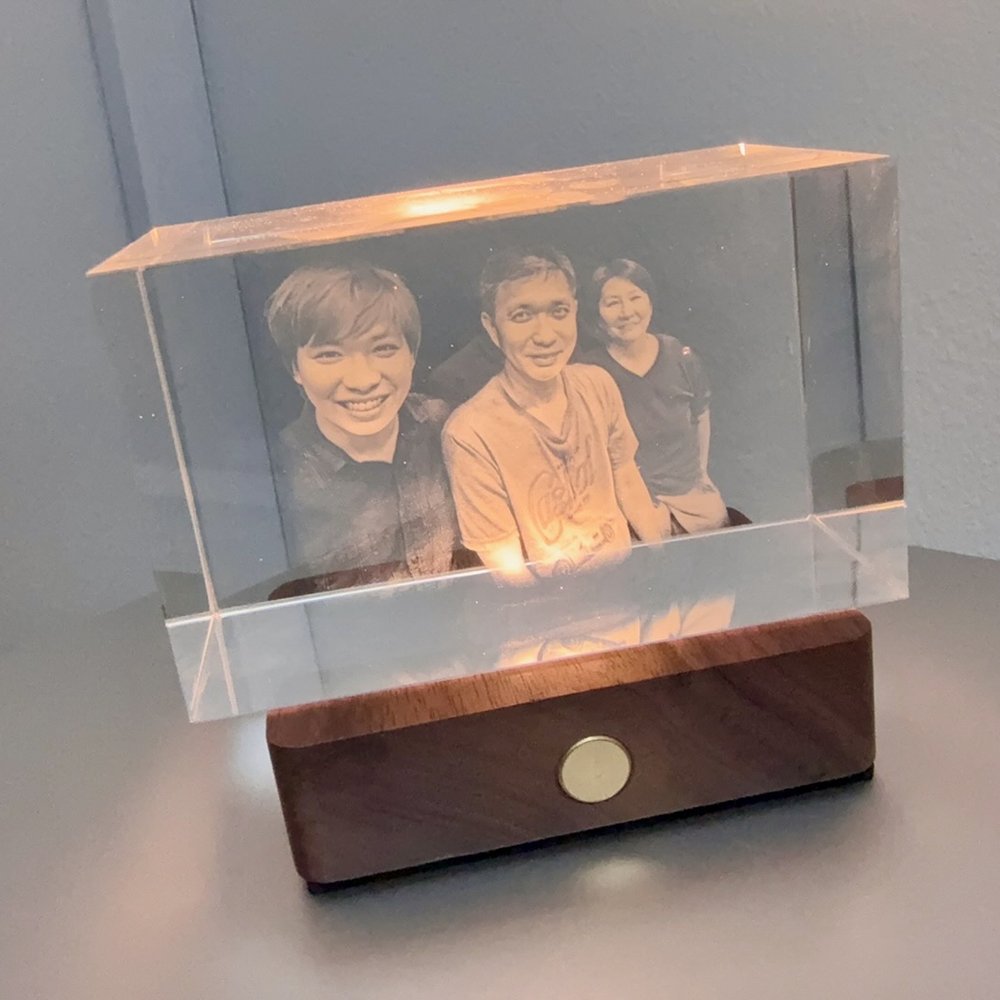 A crystal engraving of three people together