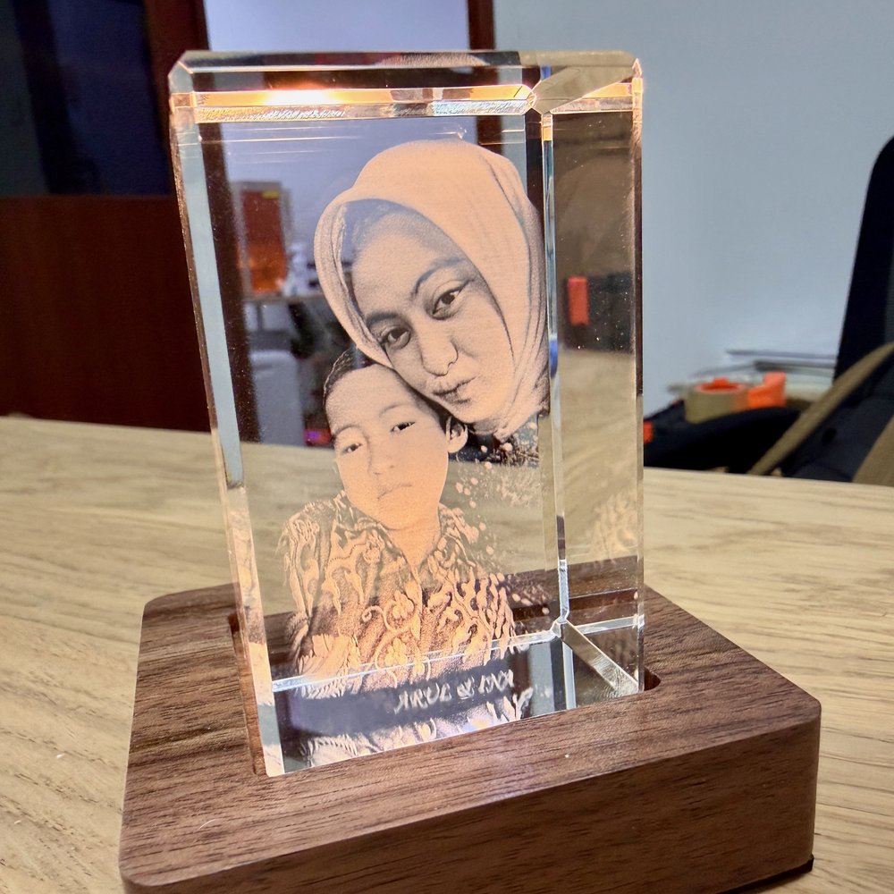 A crystal engraving of two young siblings