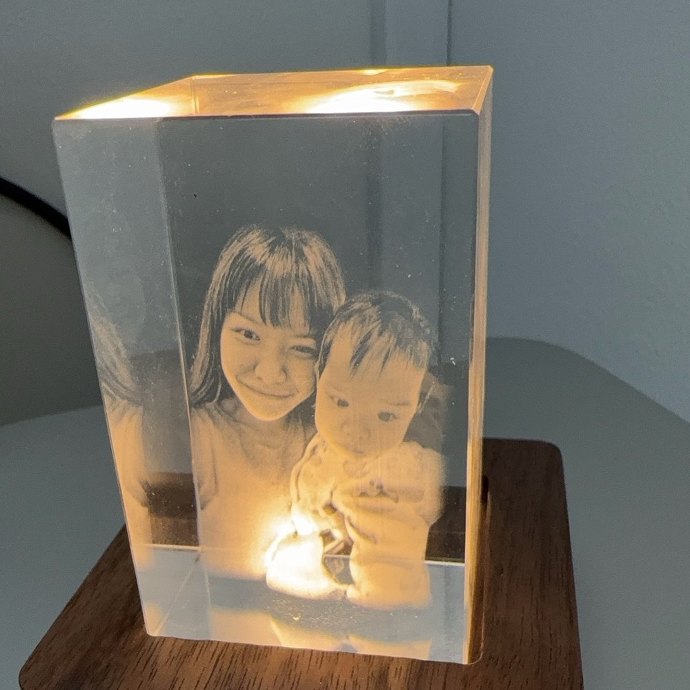 A crystal engraving of a mother and child